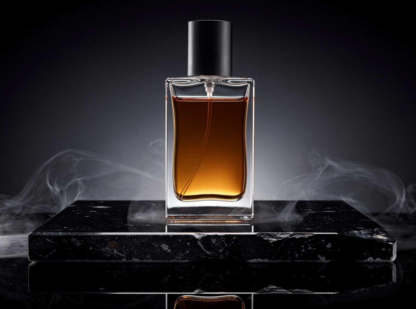 Perfume bottle on black stone